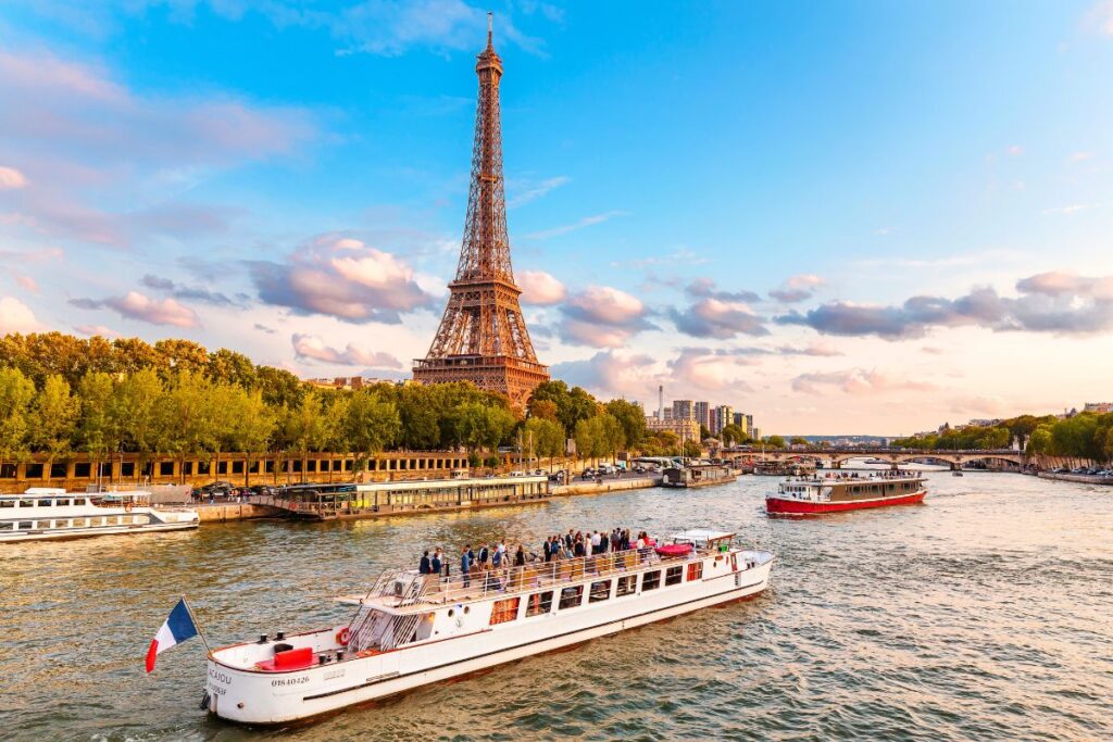 Seine river cruise Paris at sunset with Eiffel Tower in background