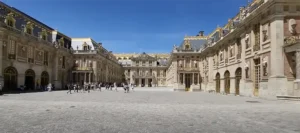 versailles palace with many people walking around