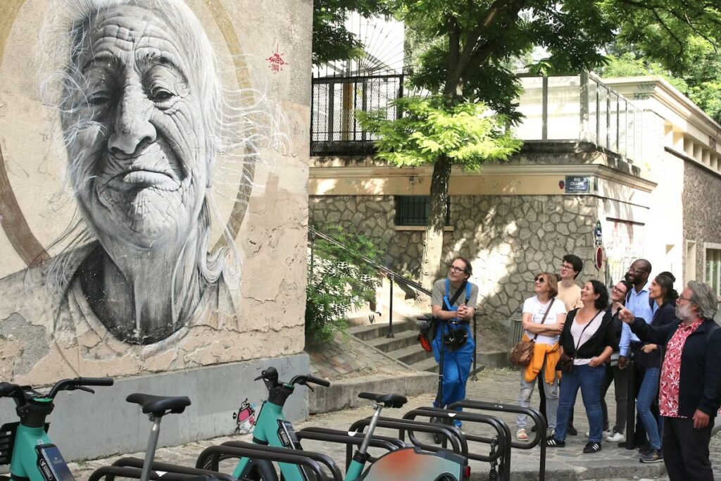 Colorful street art mural on Montmartre building in Paris